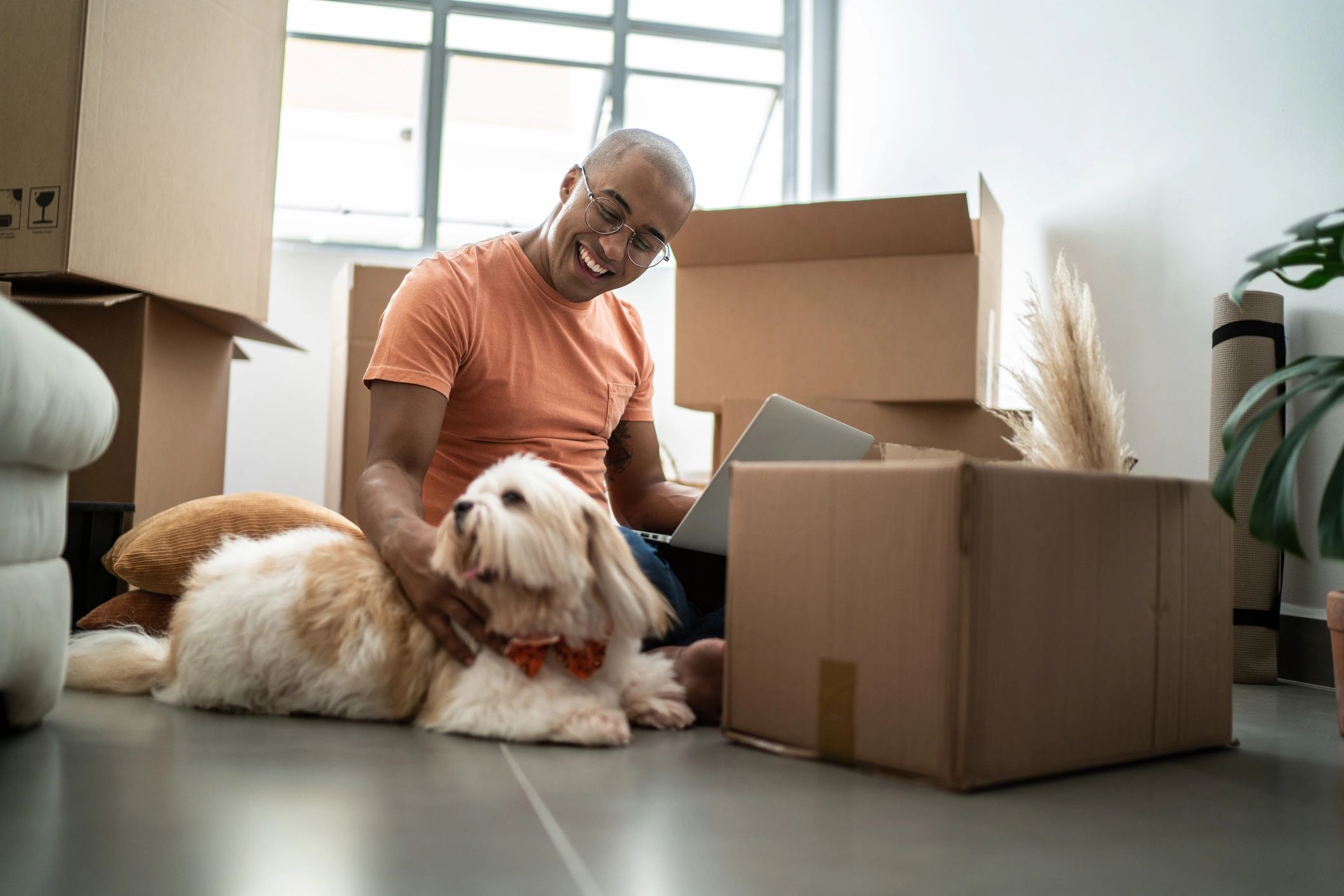 Customer at home with dog opening a package